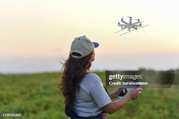 young female farmer spraying her crops using a drone - drone point of view stock pictures, royalty-free photos & images