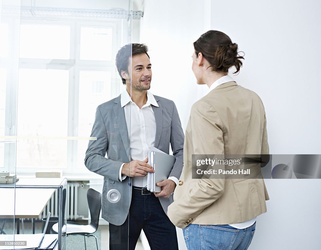 Two business people in conversation, smiling