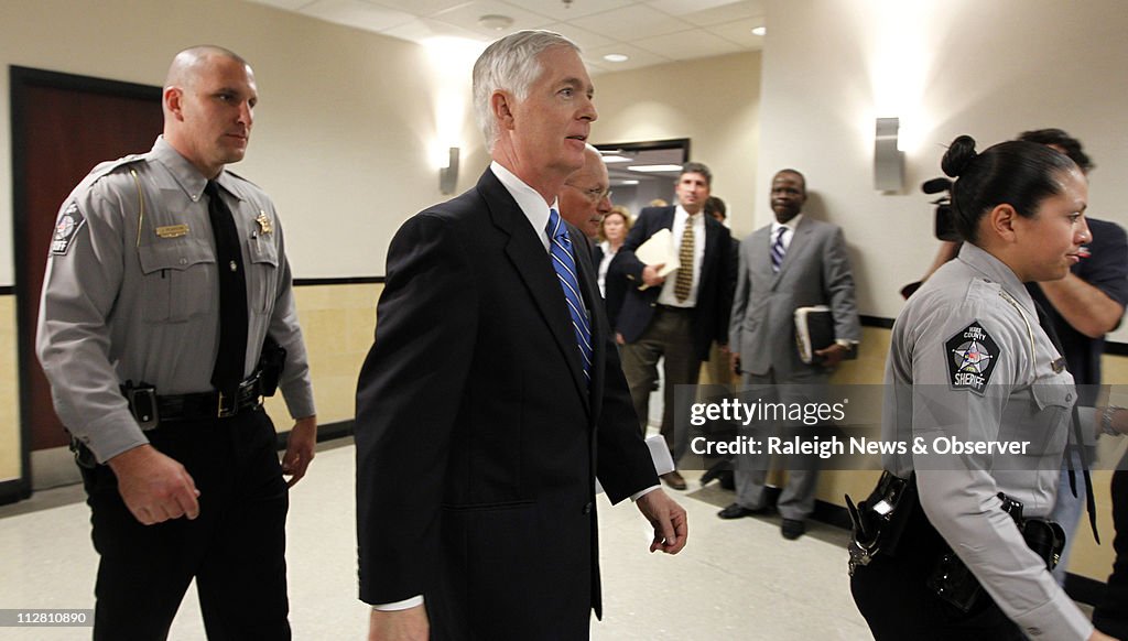 Mike Rasley Former Gov. Mike Easley, center, walks with attorney Rick Gammon ...