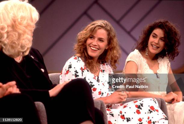 From left, American actresses Cathy Moriarty, Elizabeth Shue, and Teri Hatcher share a laugh as they promote their film 'Soapdish' on the Oprah...
