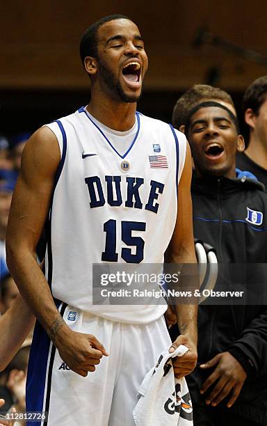 Duke forward Josh Hairston and teammate Kyrie Irving get excited after a thunderous dunk by teammate Nolan Smith in the first half of play against...