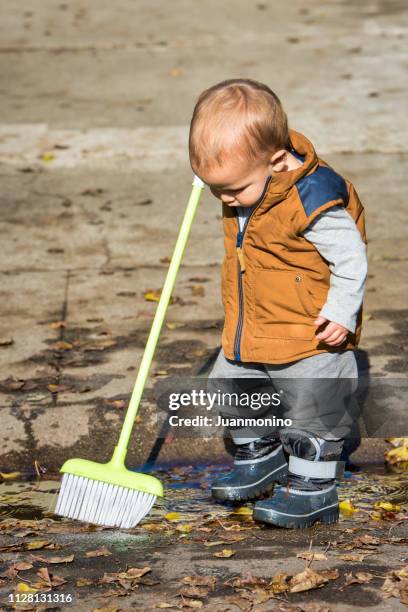 little boy doing his chores - sweeping stock pictures, royalty-free photos & images