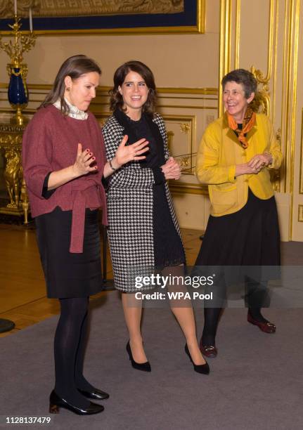 Princess Eugenie talks with Senior Curator Caroline de Guitaut and Head of Exhibitions Theresa-mary Morton during a viewing of a display of her...