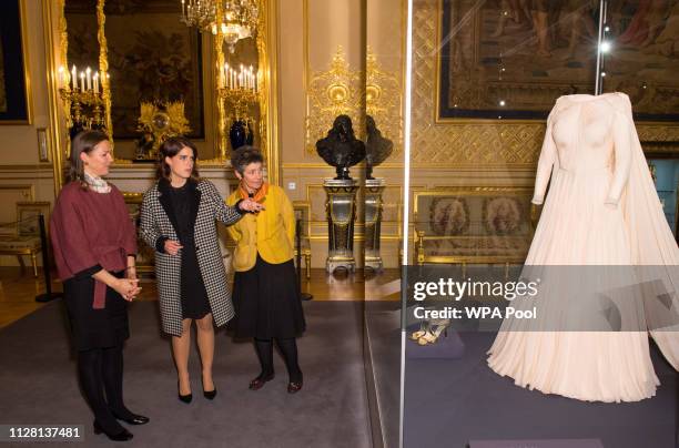 Princess Eugenie talks with Senior Curator Caroline de Guitaut and Head of Exhibitions Theresa-mary Morton during a viewing of a display of her...