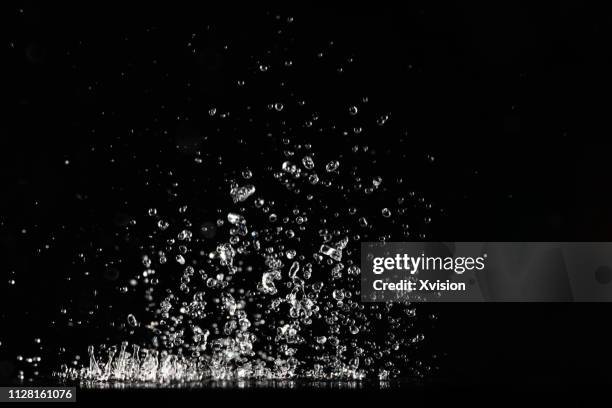 dancing water in mid air with group of small droplets"n - water splash stock pictures, royalty-free photos & images