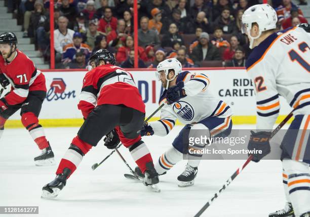 Edmonton Oilers Right Wing Josh Currie shoots the puck at goal as Ottawa Senators Defenceman Dylan Demelo attempts to defend during the first period...