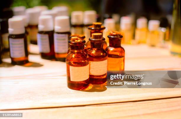 essential oil bottles on the desk of a perfumer also called a "nose" to create fragrances, in grasse, france - grasse stock pictures, royalty-free photos & images