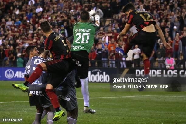 Herediano goalkeeper Daniel Cambronero stops a shot on goal in the second half of the CONCACAF Champions League playoff football match between...