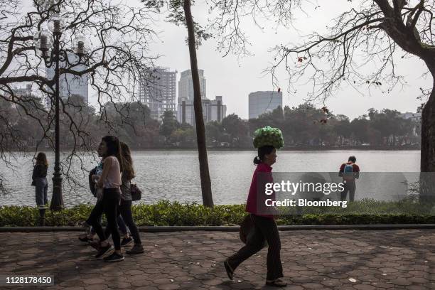 Pedestrians walk along a footpath around Hoan Kiem Lake in Hanoi, Vietnam, on Friday, March 1, 2019. North Korean leader Kim Jong Un vowed to meet...