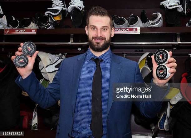 Brad Richardson of the Arizona Coyotes holds the pucks from his four goals against the Vancouver Canucks following a 5-2 victory at Gila River Arena...