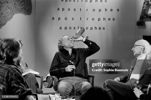 American poet, novelist and short story writer Charles Bukowski, drinking on the set of the French TV program Apostrophes hosted by Bernard Pivot.