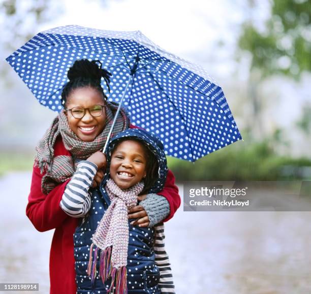 we love rainy season - standing in the rain girl stock pictures, royalty-free photos & images