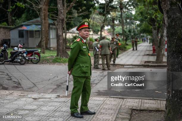 Police officers guard a road near the Presidential Palace ahead of the arrival of North Korean leader Kim Jong-un on March 1, 2019 in Hanoi, Vietnam....