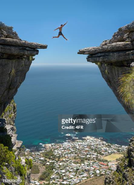 jump! believe in yourself - ocean cliff stock pictures, royalty-free photos & images