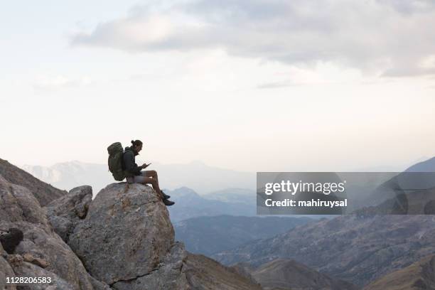 hiker use smartphone at mountain peak - cliff climb stock pictures, royalty-free photos & images