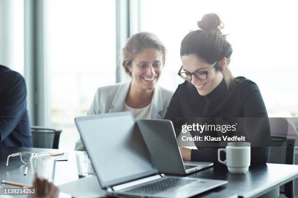co-workers having meeting with laptop in conference room - coffee table stock photos et images de collection