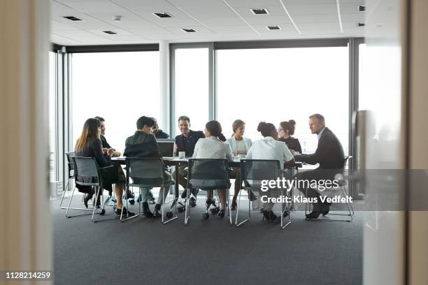 co-workers having meeting with laptop in conference room - big conference event stock pictures, royalty-free photos & images