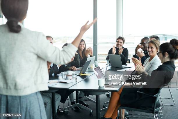 businesswoman doing presentation in big boardroom - board room stock-fotos und bilder