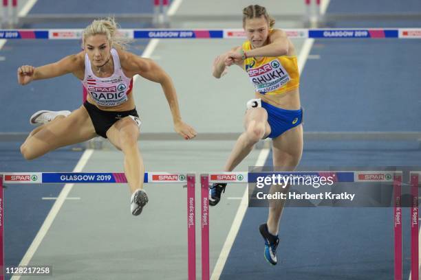 Ivona Dadic of Austria and Alina Shukh of the Ukraine compete in the 60m hurdles event of the women's pentathlon on March 1, 2019 in Glasgow, United...