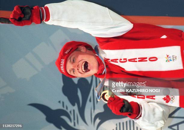 Canada's Ross Rebagliati celebrates receiving the first ever Olympic gold medal in snowboarding in Nagano 08 February, having won the Giant Slalom...