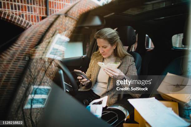 businesswoman working through lunch - on the move stock pictures, royalty-free photos & images