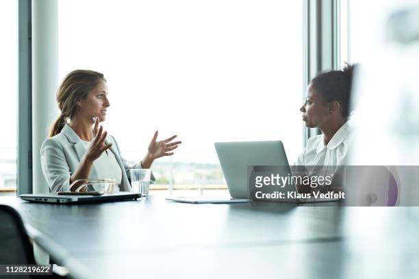 businesswomen having meeting with laptops in boardroom - trabalhadora de colarinho branco - fotografias e filmes do acervo