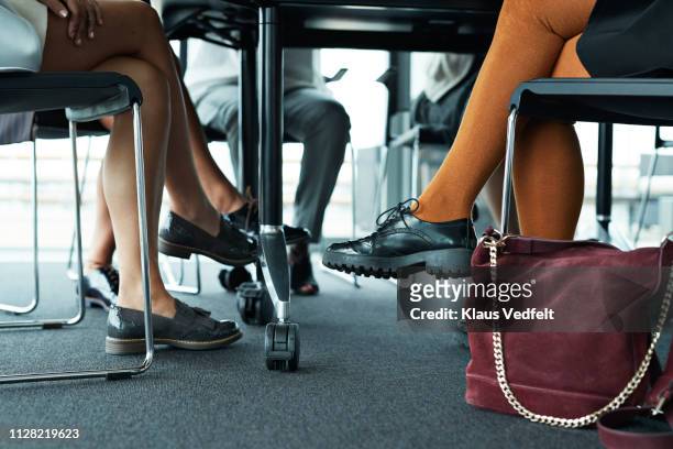 group of businesswomen having meeting in boardroom - pernas cruzadas imagens e fotografias de stock