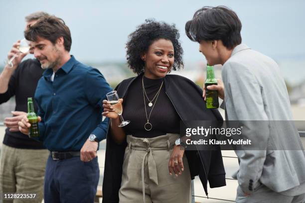 corporate co-workers having drinks after meeting - man sipping beer smiling photos et images de collection