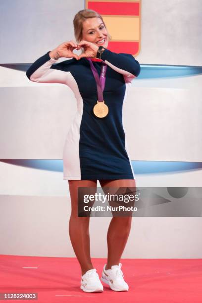 Spanish weightlifter Lydia Valentin poses with her London 2012 Olympic Games gold medal during a ceremony held at the Spanish Olympic Committee's...