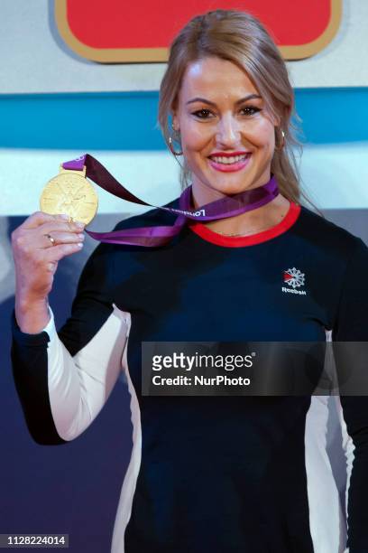 Spanish weightlifter Lydia Valentin poses with her London 2012 Olympic Games gold medal during a ceremony held at the Spanish Olympic Committee's...