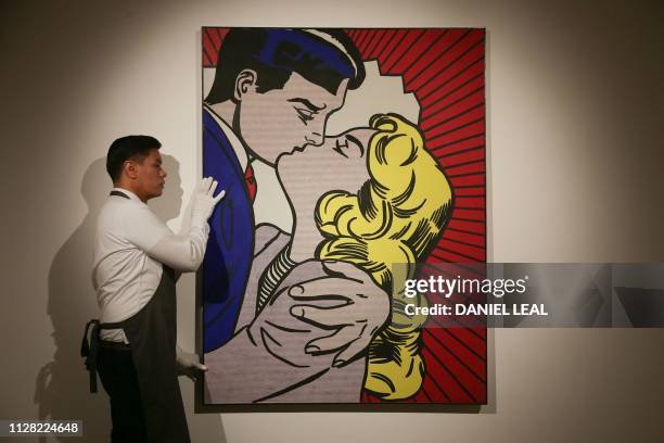 Christie's employee positions with the painting entitled 'Kiss II' by US artist Roy Lichtenstein, estimated to be sold for 22 million GBP at a...