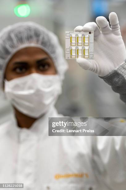 Technician checks the printed circuit board of a high-performance switching electronic at a Continental AG Powertrain production facility on March 1,...
