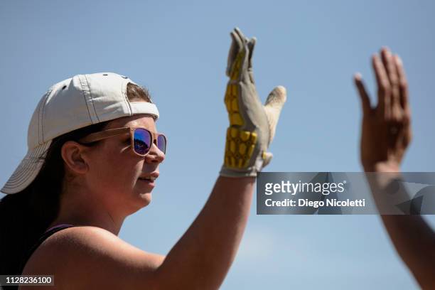 female softball player celebrating with high five - softball glove stock pictures, royalty-free photos & images