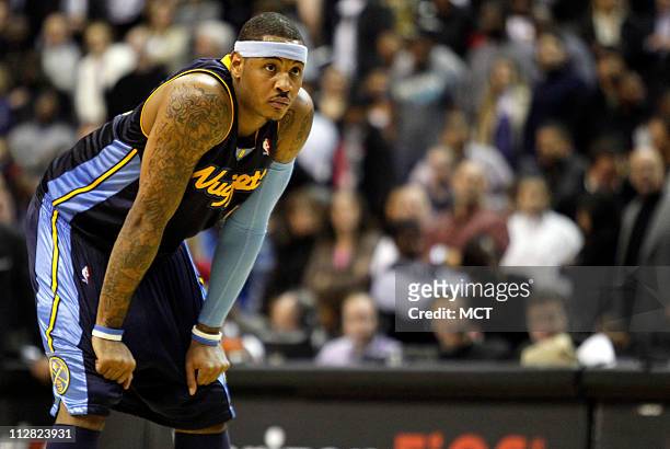 The Denver Nuggets' Carmelo Anthony watches as the Washington Wizards tack on points at the free throw line during the second half at the Verizon...