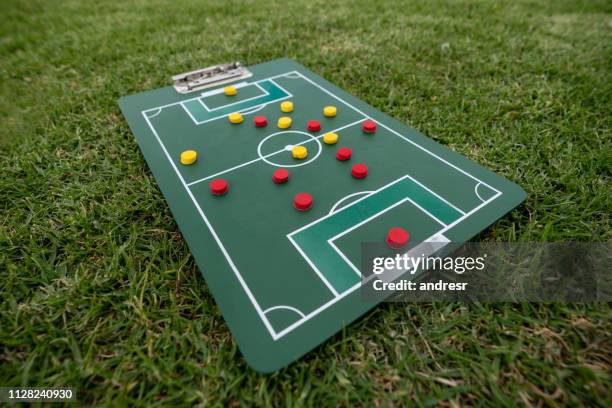 close-up on a strategy board with the line up at a soccer field - football game plan stock pictures, royalty-free photos & images