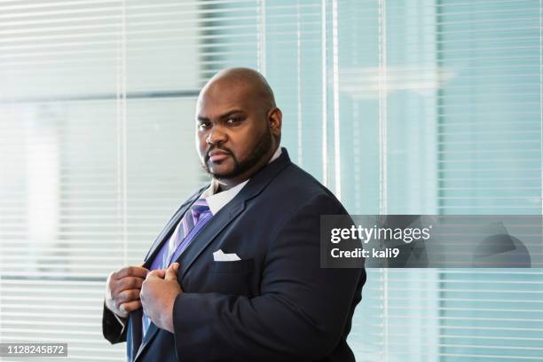 african-american businessman with large build, frowning - overweight 40 year old male concerned stock pictures, royalty-free photos & images