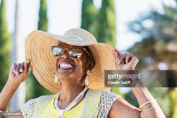 femme senior afro-américaine lunettes de soleil - woman hat photos et images de collection