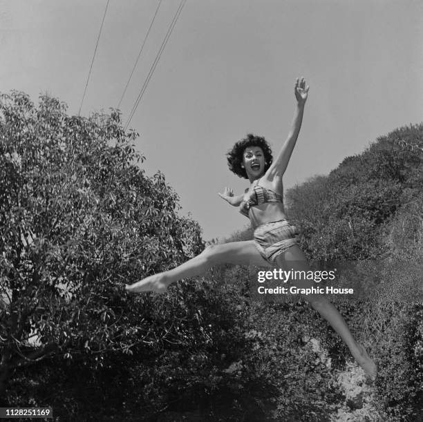 Puerto Rican actress, dancer and singer Rita Moreno jumping in a bikini, US, 5th October 1951.