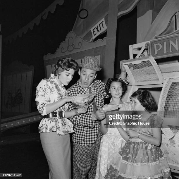 American actress Natalie Wood with her sister Lana Wood and American burlesque comic and television presenter Pinky Lee at a local circus, US, 6th...