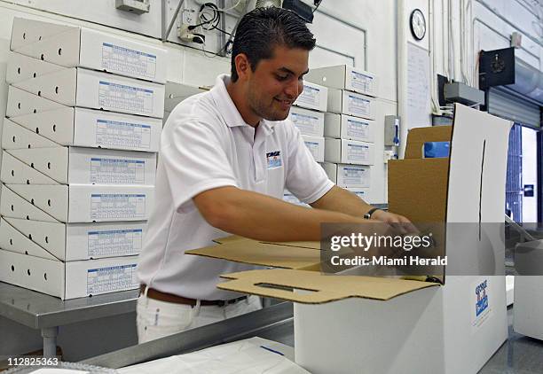 Roger Duarte prepares a 4-lb. Box of stone crab for delivery, October 13 in Miami, Florida. Duarte is a former investment banker who last year...