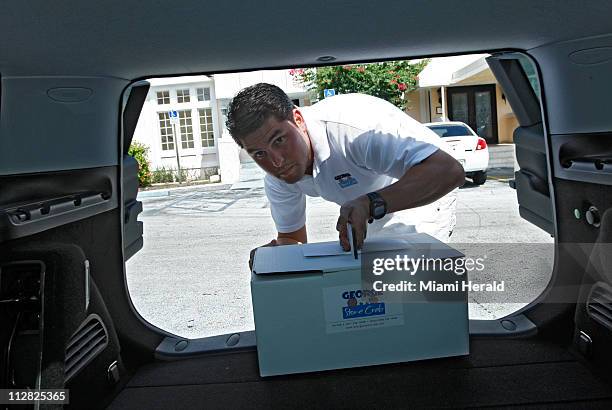 Roger Duarte dressed in white makes a delivery, October 13 in Miami, Florida. Duarte is a former investment banker who last year switched careers...