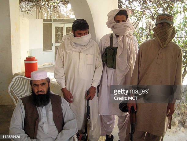 Spiritual leader and a founder of the anti-Taliban militia, Maulvi Sher Mohammad, is seated with some of his guards, in Dera Ismail Khan.