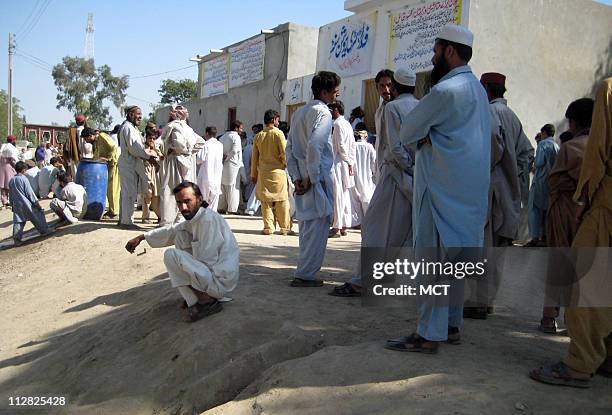 Spiritual leader and a founder of the anti-Taliban militia, Maulvi Sher Mohammad, is seated with some of his guards, in Dera Ismail Khan.