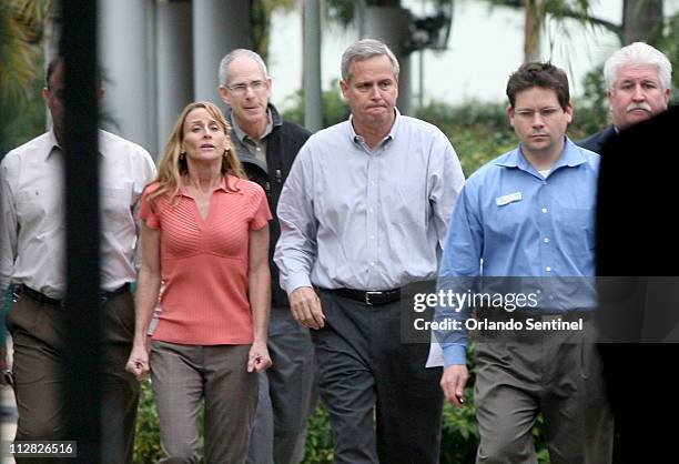 Dan Brown, general manager of SeaWorld Adventure Park, center, walks with Kelly Flaherty Clark, left, curator of animal training at SeaWorld, prior...