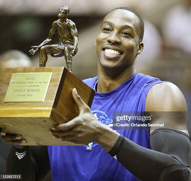 Orlando Magic center Dwight Howard holds the defensive player of the year trophy before the start of Game 2 of the first round of the NBA Eastern...