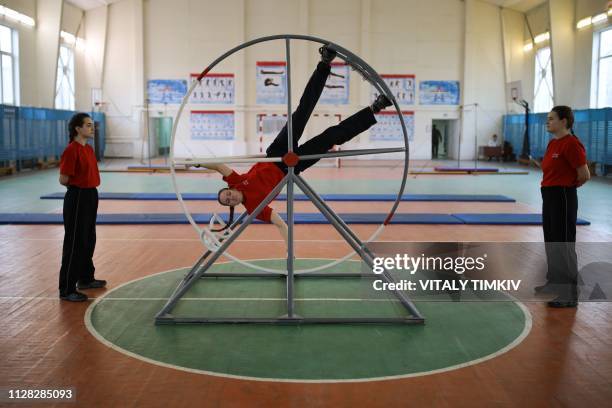 Female cadets exercise during a class at the Krasnodar Higher Military Aviation School in Krasnodar on March 1, 2019.