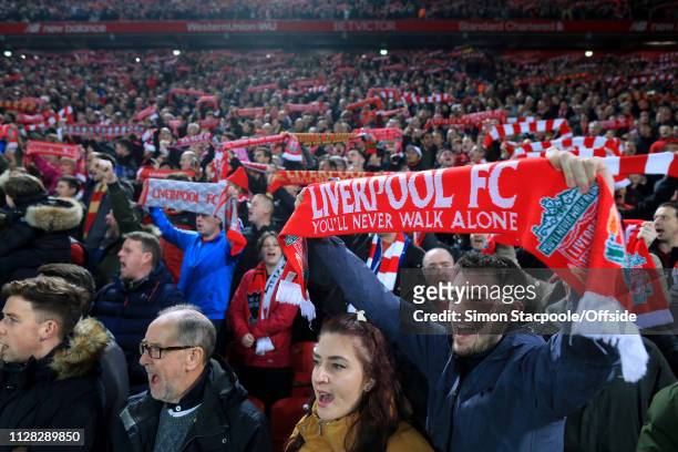 Liverpool fans hold their scarves aloft as they sing 'You'll Never Walk Alone' before the Premier League match between Liverpool and Watford at...