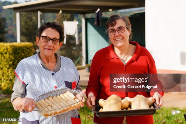 mother and daughter showing what they have cooked - cannelloni stock pictures, royalty-free photos & images