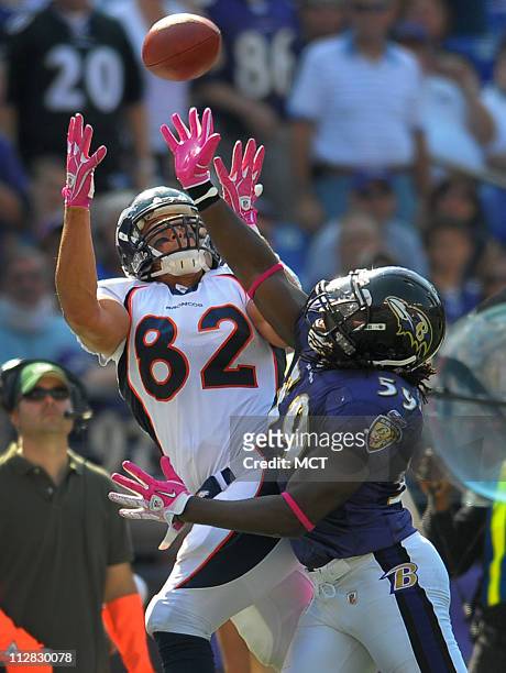 Denver Broncos tight end Dan Gronkowski can't corral a pass early in the third quarter as Baltimore Ravens linebacker Jason Phillips defends on the...