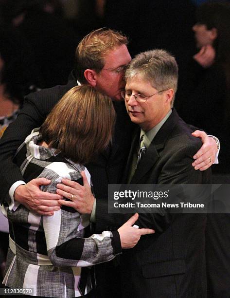 Life Center Church Pastor Dean Curry, center, embraces Ken Paulson and Cindy Paulson following a memorial service for Ken's daughter Jennifer Paulson...